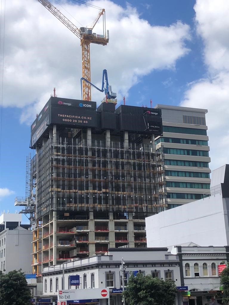 Mid-construction stage of The Pacifica tower in Auckland CBD, featuring formwork, cranes, and Advanced Concrete Pumping equipment operating on site.