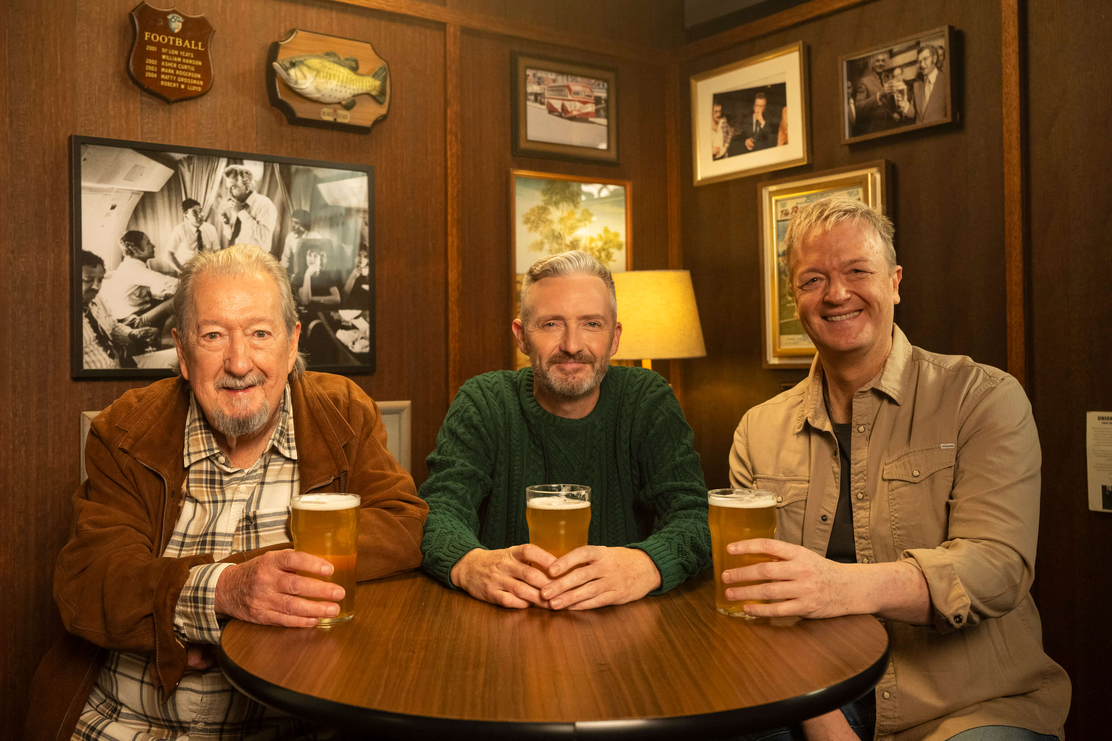 The Kerrigans sitting in the back seat of an Uber Green car, smiling and wearing seatbelts, featured in Uber’s ‘True Blue’ Uber Green campaign.