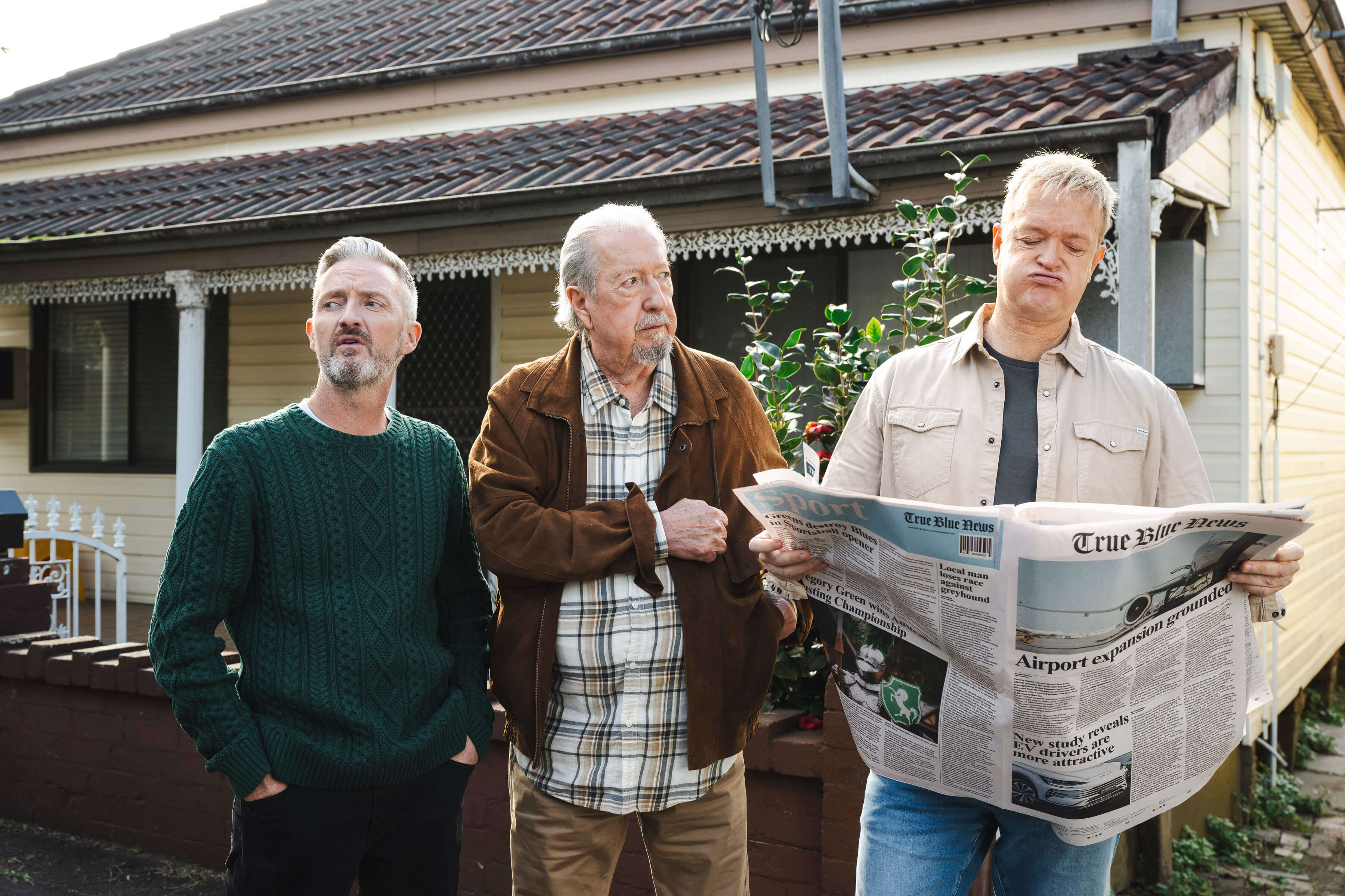 F1 Driver, Valtteri Bottas wearing a turquoise Uber Carshare outfit, standing in front of a branded car in suburban Australia for the Uber Carshare campaign.