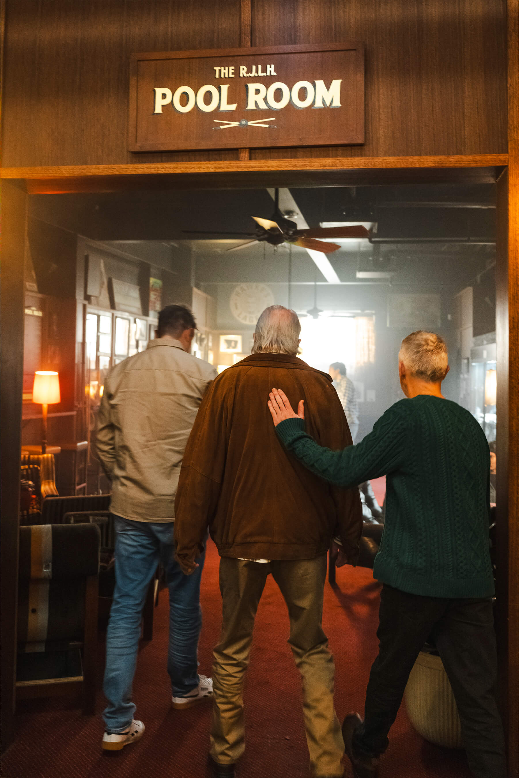 The Kerrigans sitting in the back seat of an Uber Green car, smiling and wearing seatbelts, featured in Uber’s ‘True Blue’ Uber Green campaign.