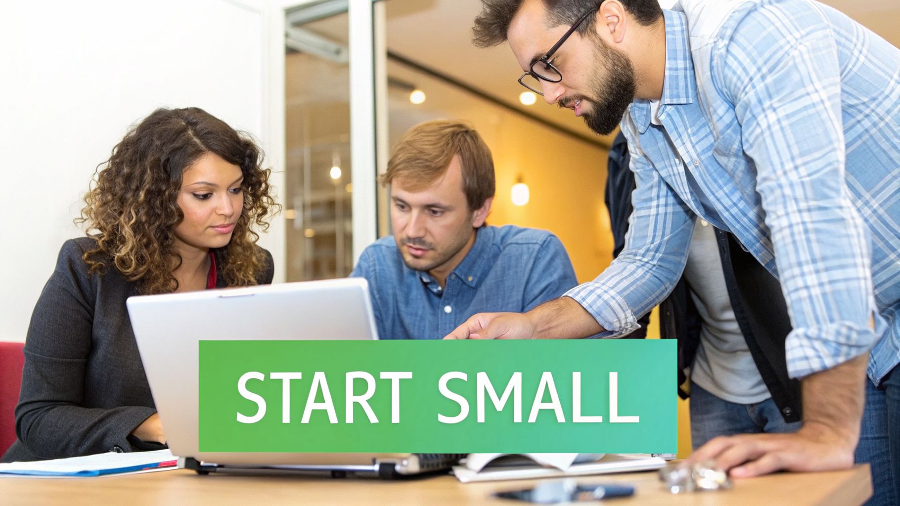 Three colleagues collaborating around a laptop, with a green 'START SMALL' banner in the foreground.