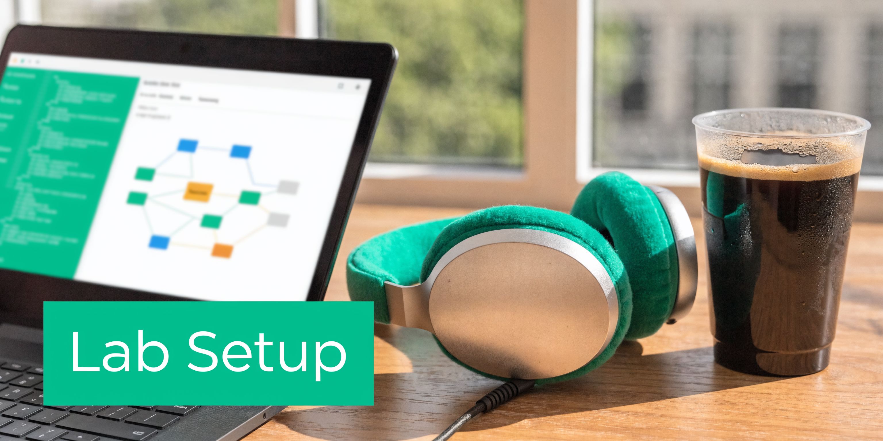 A laptop showing a network diagram, green headphones, and a cup of coffee on a wooden desk.