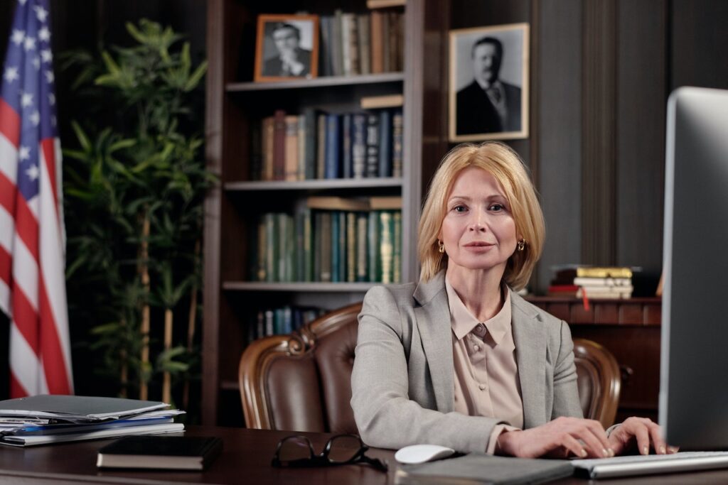 an immigration lawyer sitting down behind a desk