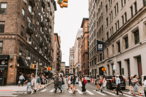  a group or pedestrians crossing a busy New York Street