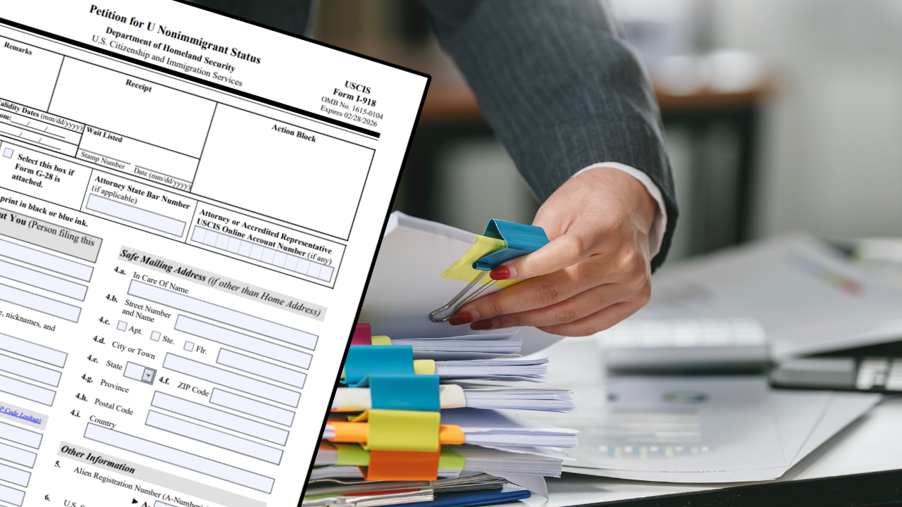 a man in asuit holding files with USCIS Form I-918