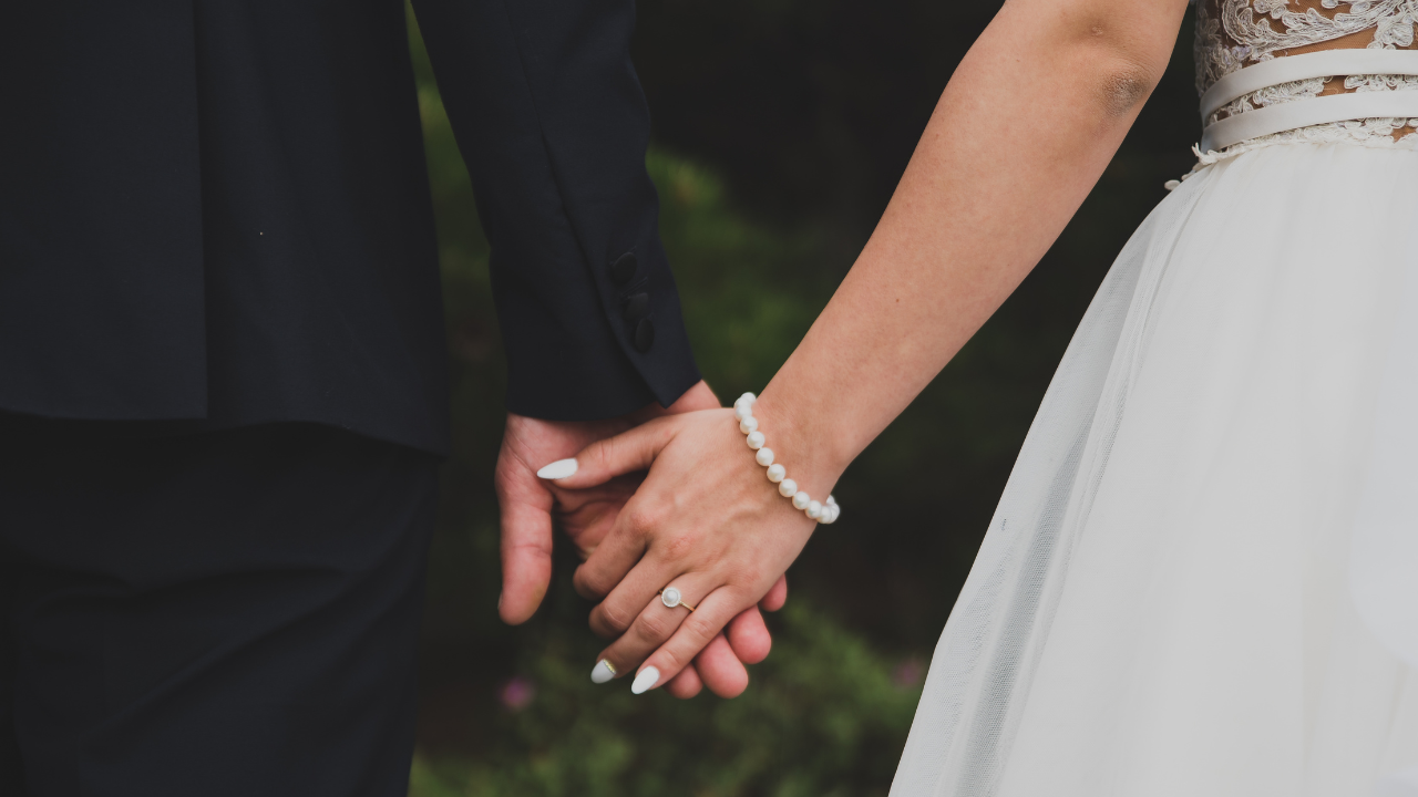 newly wed holding hands 