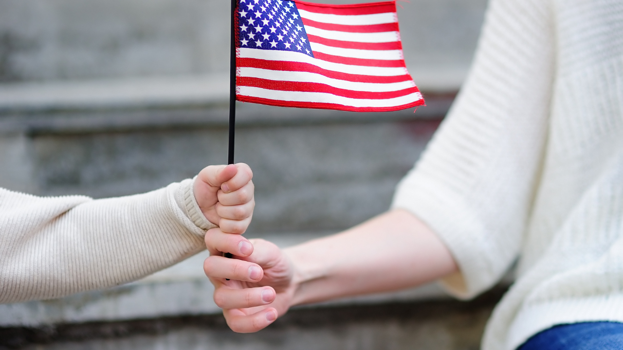 woman and child holding a us flag