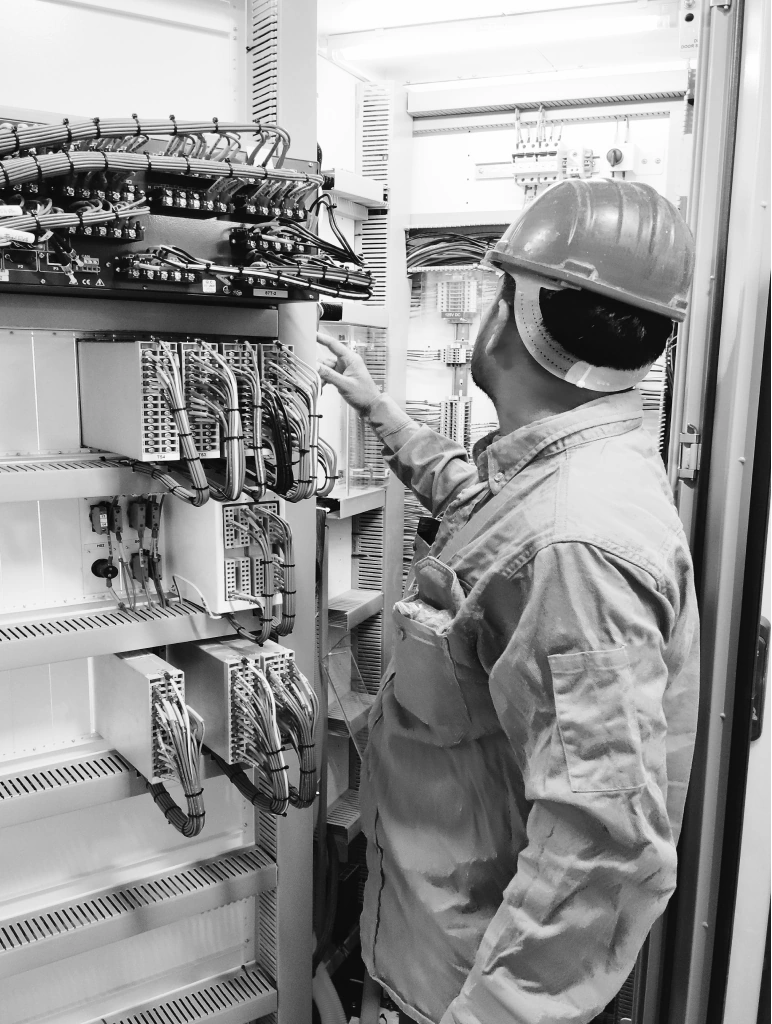Electrical engineer working on industrial equipment