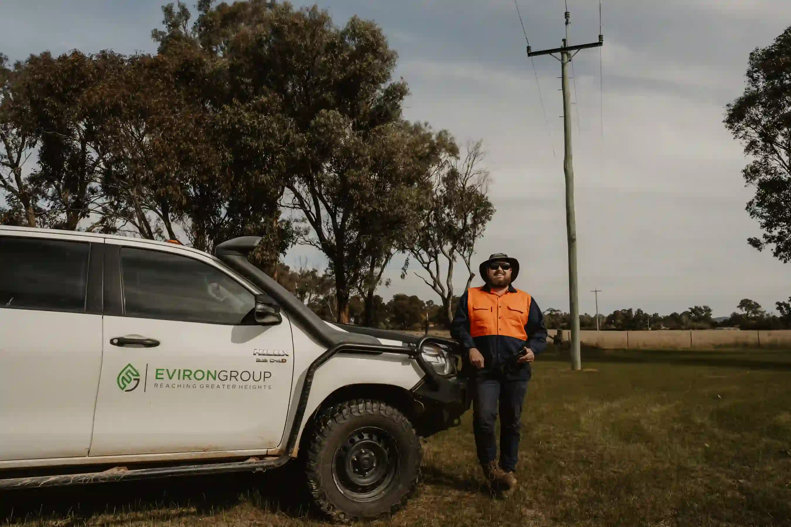 A man standing next to a white truck.