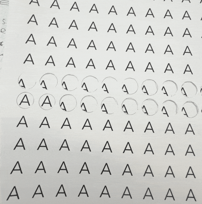 Sheet with rows of the letter 'A' in uppercase, with some letters circled and partially erased.
