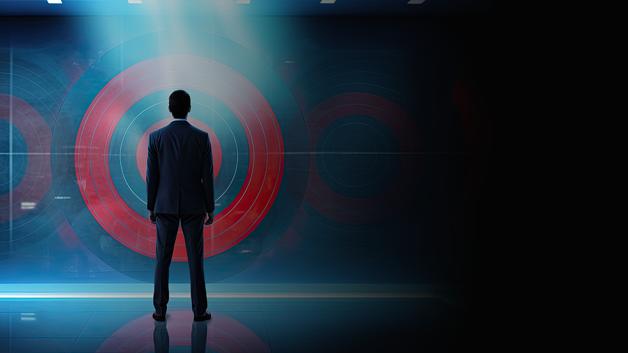 Man in a suit standing and facing a large translucent target symbol with concentric circles.
