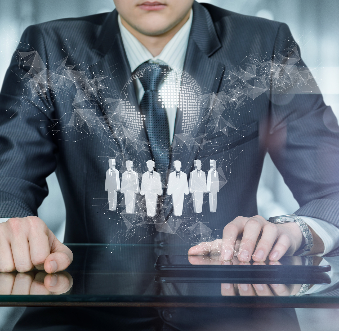 Businessman in suit interacting with tablet displaying digital network of connected businesspeople icons and a globe.