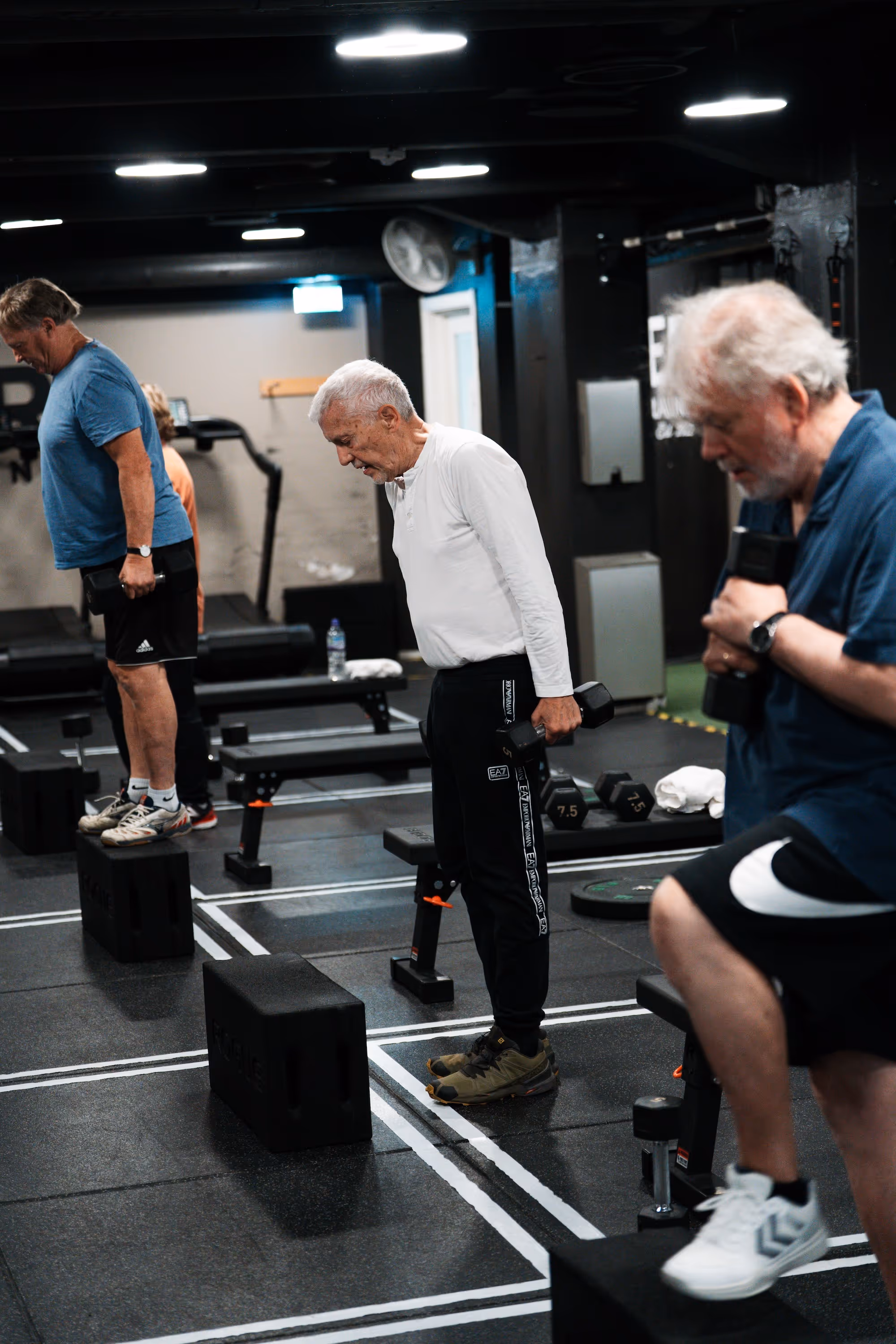 3 menn som trener med å gå på kasse.