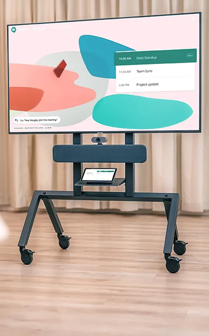 Écran de réunion sur support à roulettes affichant un planning avec des réunions prévues à 10:00, 11:30 et 14:30.