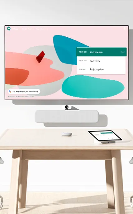 Salle de réunion avec un grand écran affichant un calendrier de réunion et une tablette posée sur une table en bois clair.