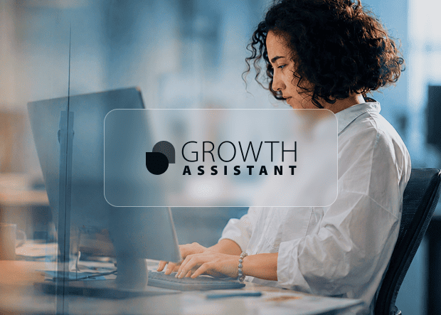 A Growth Assistant working at her desk on a laptop