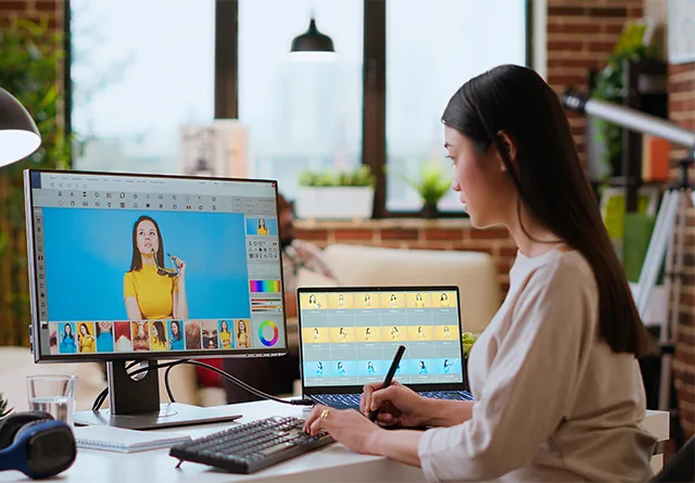 Graphic designer editing product photos with a stylus at her desk.