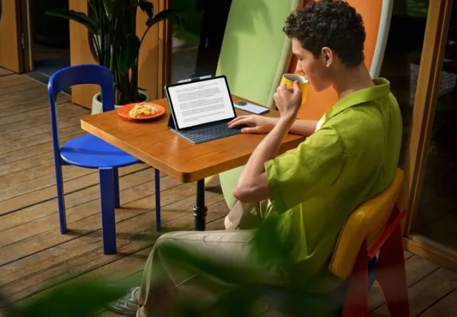 Man reading a team working agreement on his tablet outdoors.