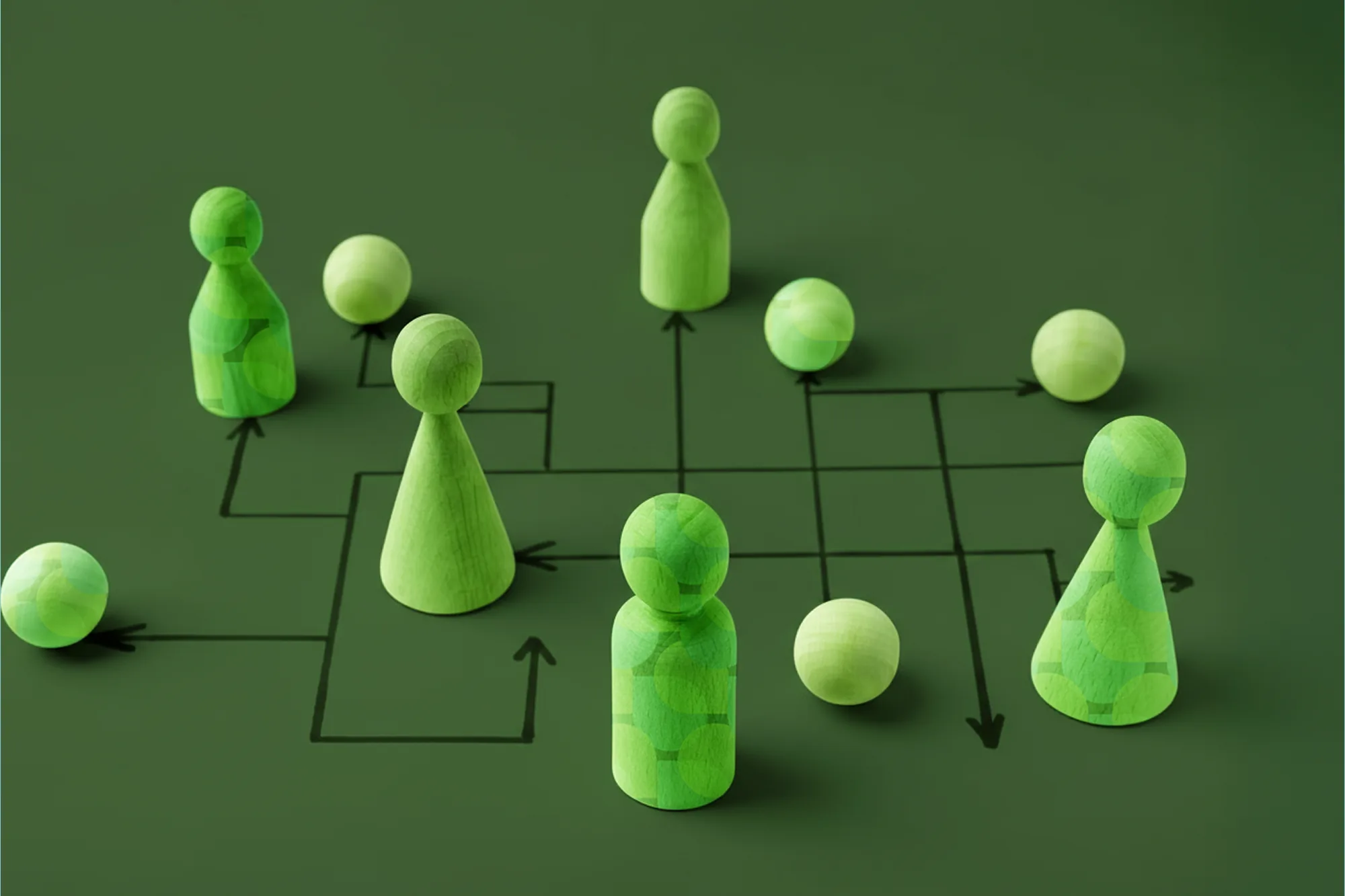 Wooden figures connected by flowchart lines illustrating creative agency org design.