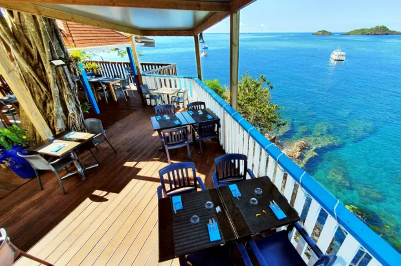 A restaurant table with the sea as the background
