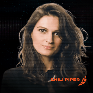 Smiling young woman with long light brown hair against a dark digital background.