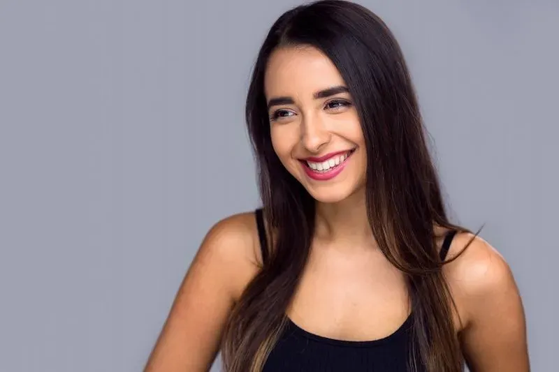 A woman with long hair smiling.