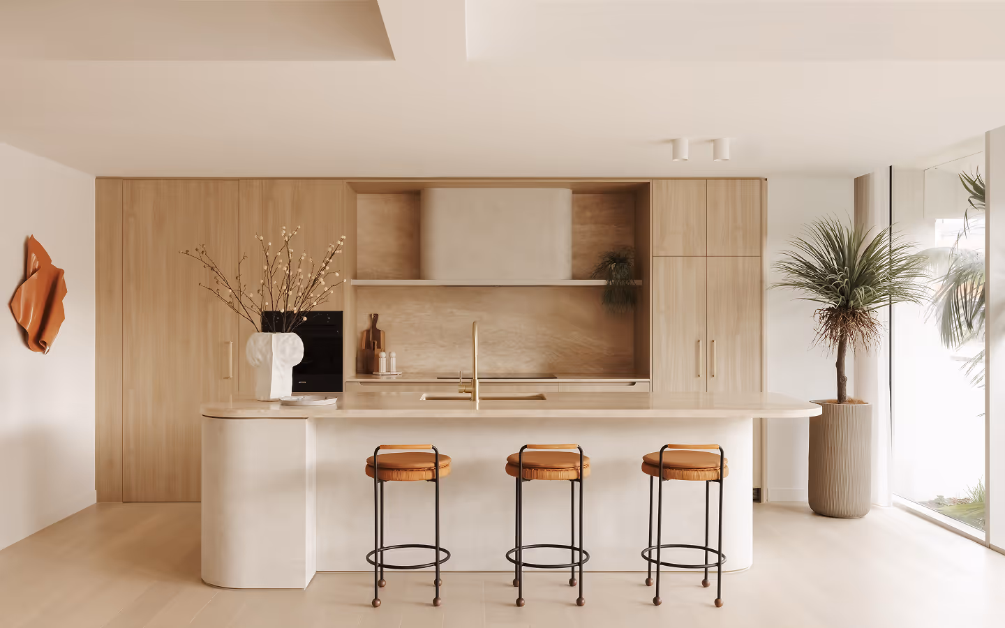 Light wood dining table with modern cream chairs and ceramic vase with dried branches near sheer white curtains.
