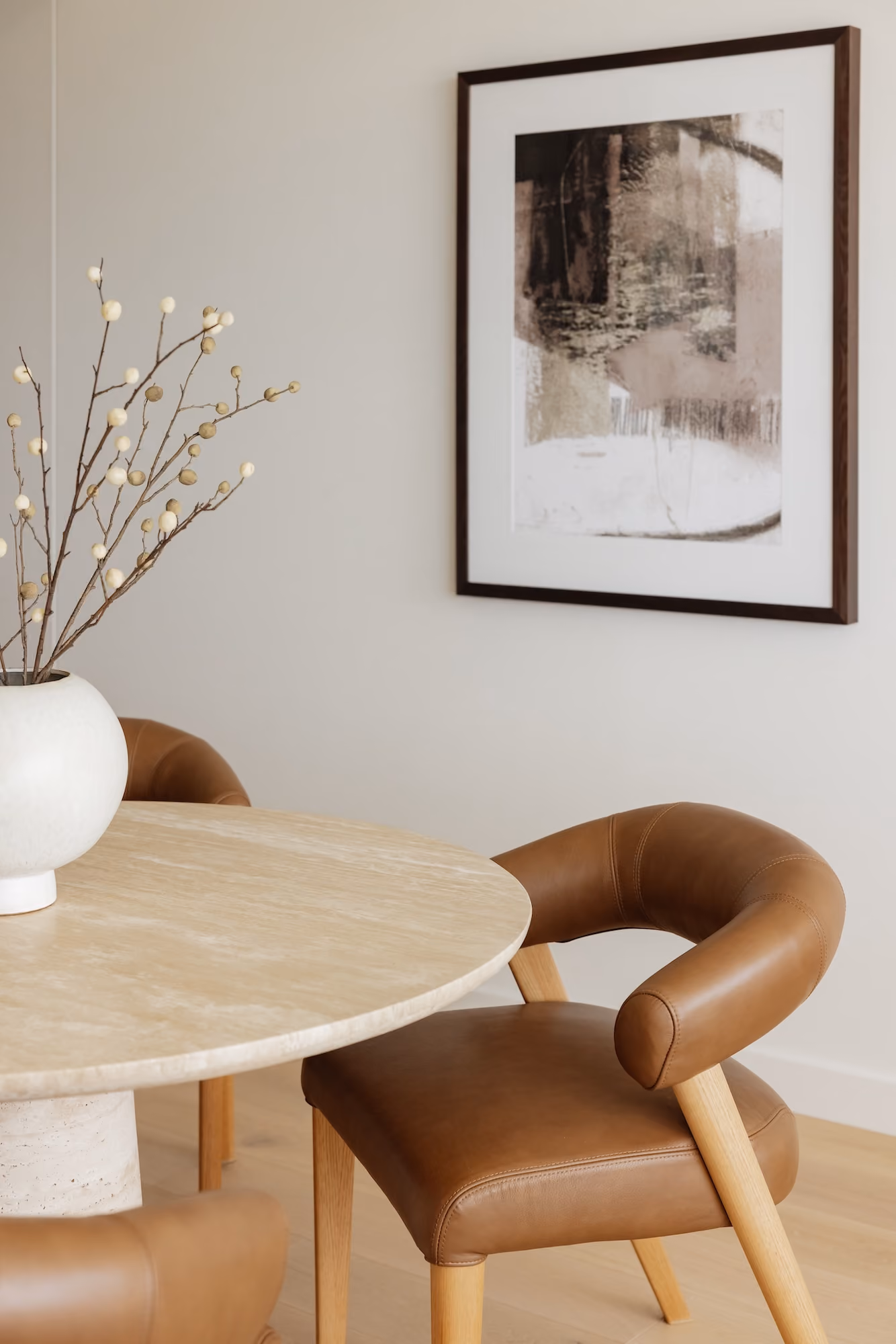 Minimalist kitchen and dining area with wooden furniture, white walls, and large sheer curtains.