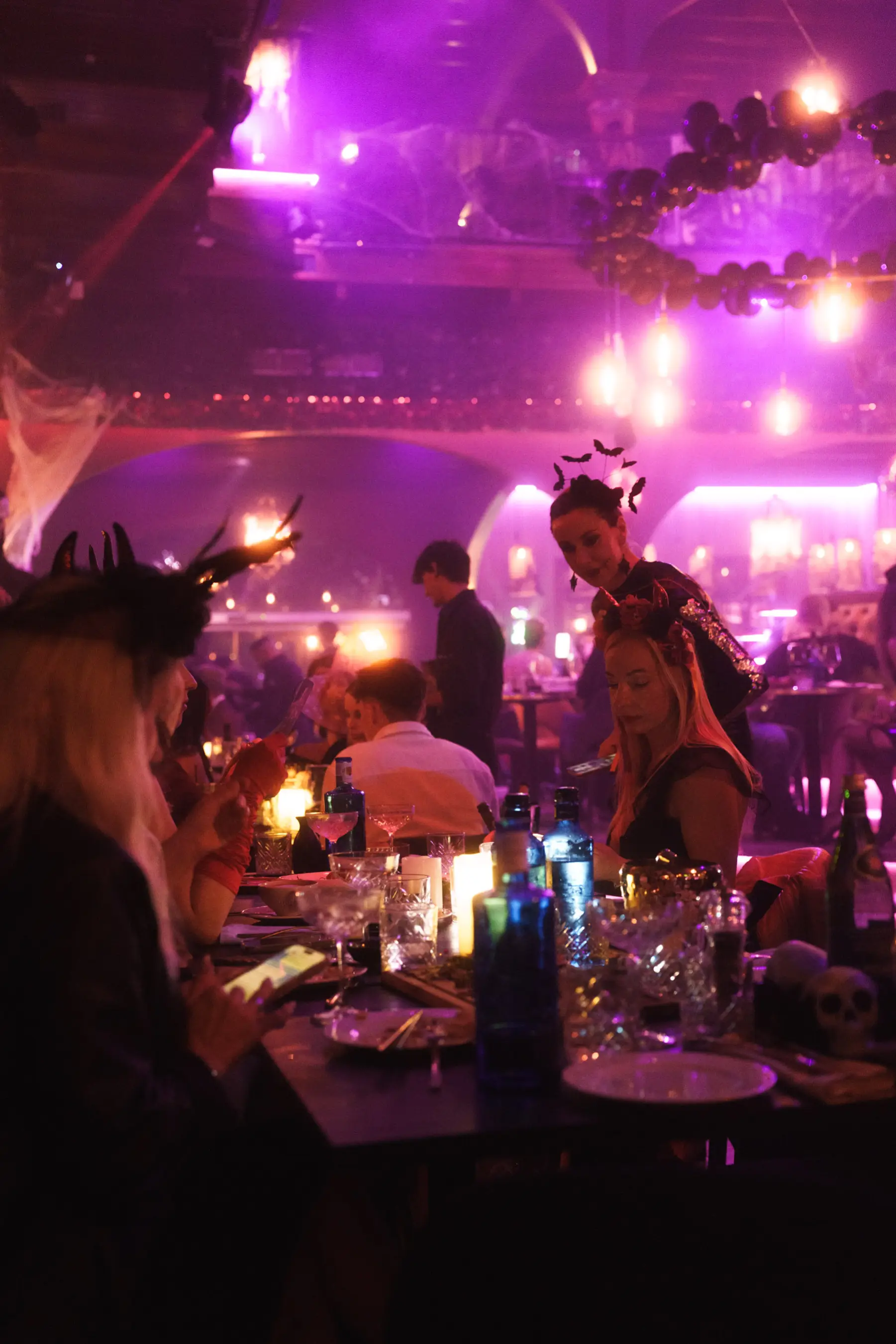 Guests wearing neon masks and costumes during Tabana’s Halloween event in Mallorca.