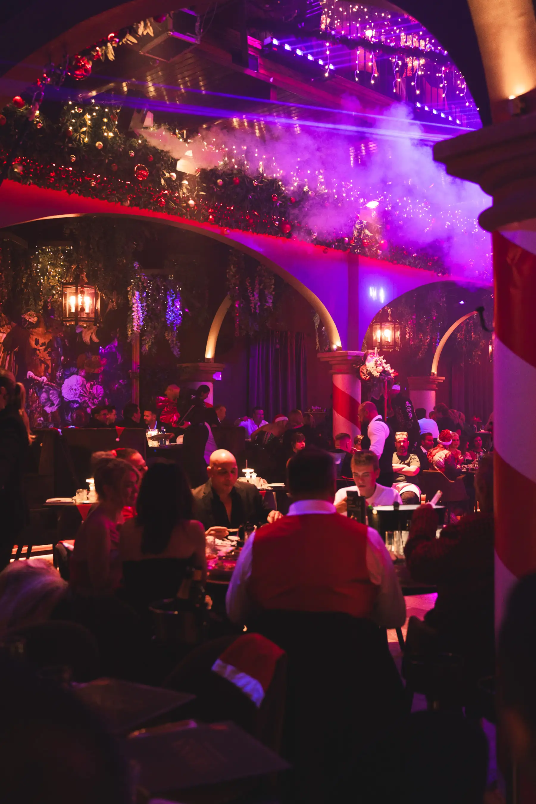 Group of guests enjoying cocktails and celebrations inside Tabana at the Dirty Santa event.