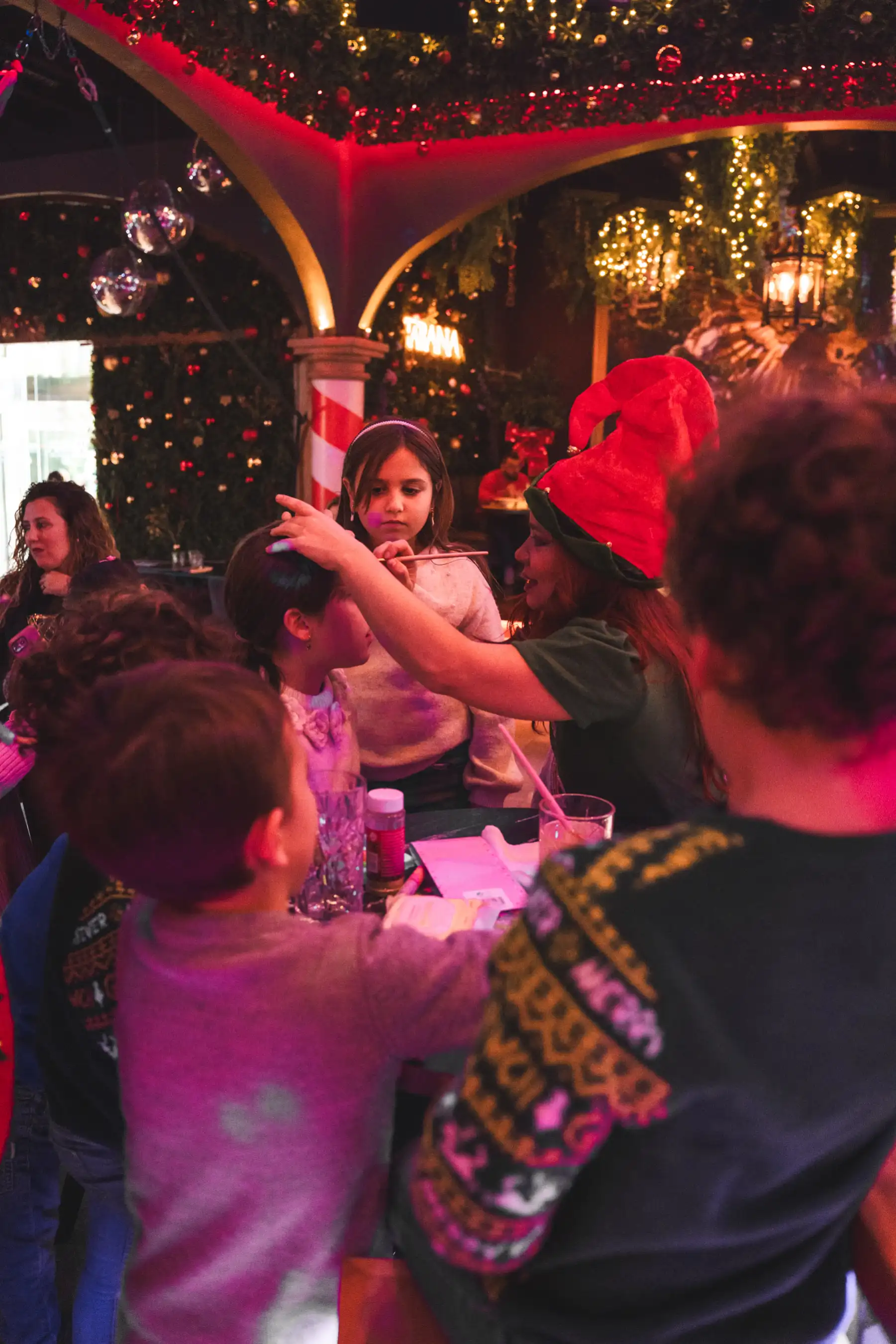 Child with painted face enjoying Santa’s Lunch family event at Tabana Mallorca