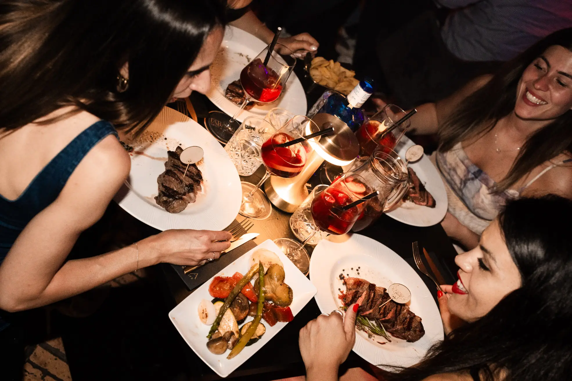Group of friends enjoying dinner with at one of tabanas shows