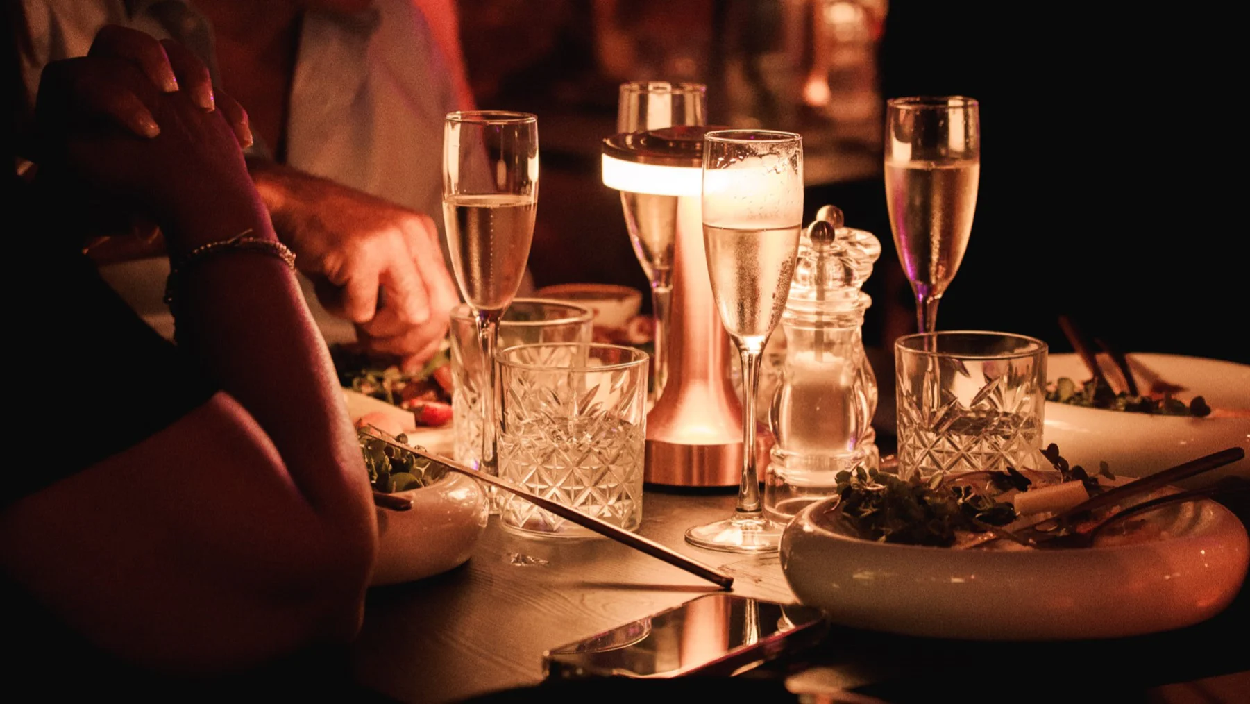 A group of people enjoying a meal together at a table in Tabana, reflecting a lively dining atmosphere.