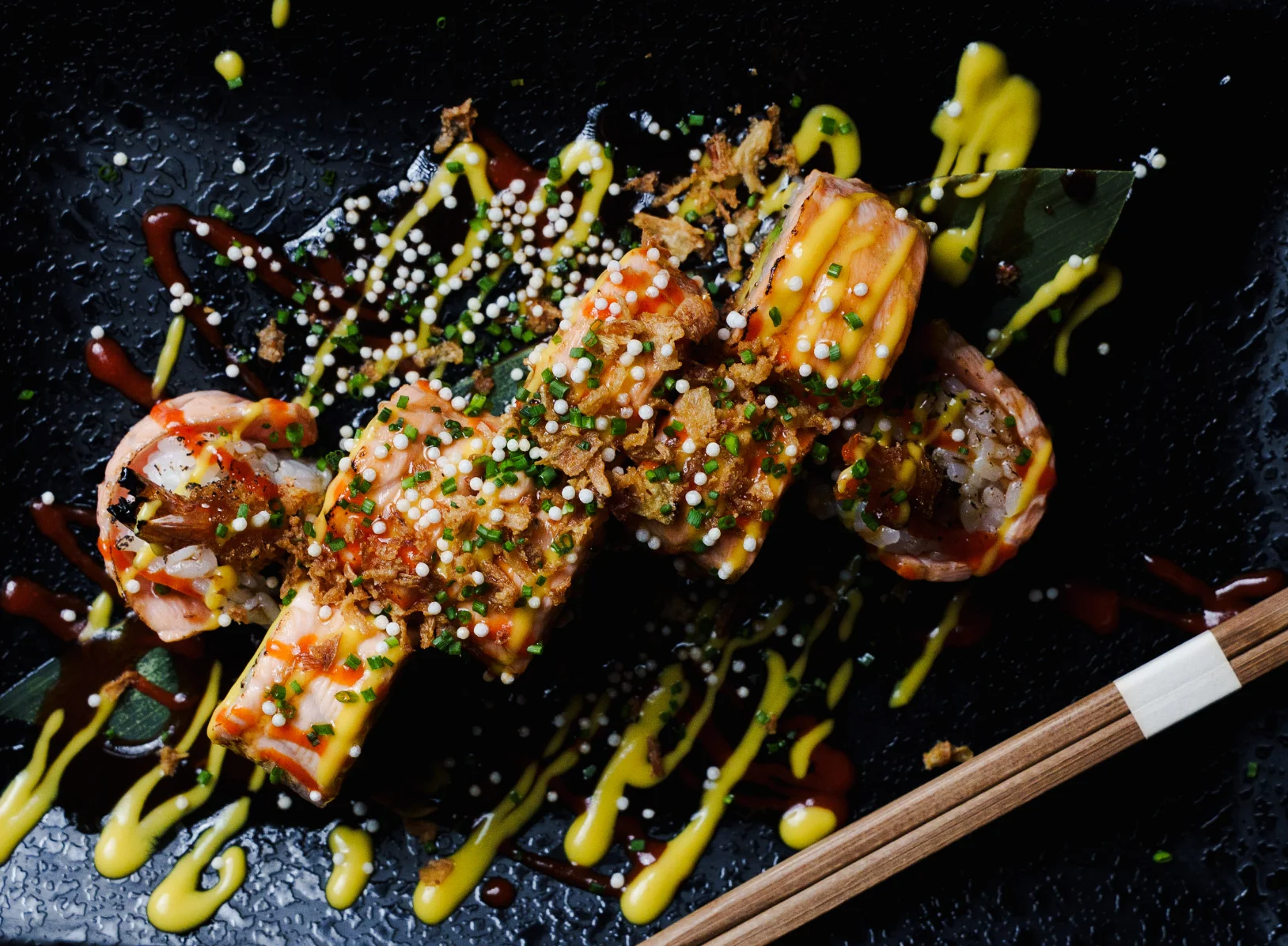 Salmon sushi rolls with sauce and chives at Tabana dinner show restaurant, Playa de Palma, Mallorca