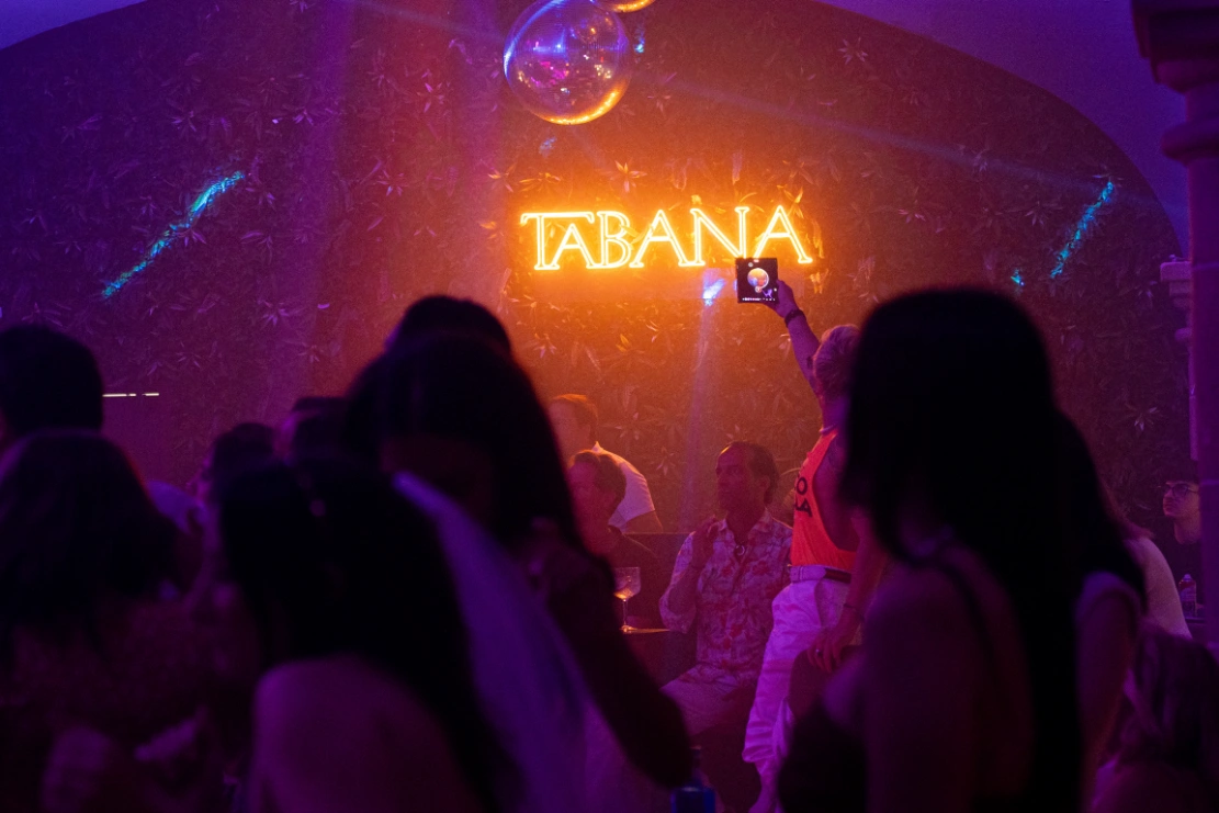 Party atmosphere under the Tabana neon sign at the dinner show venue in Playa de Palma, Mallorca