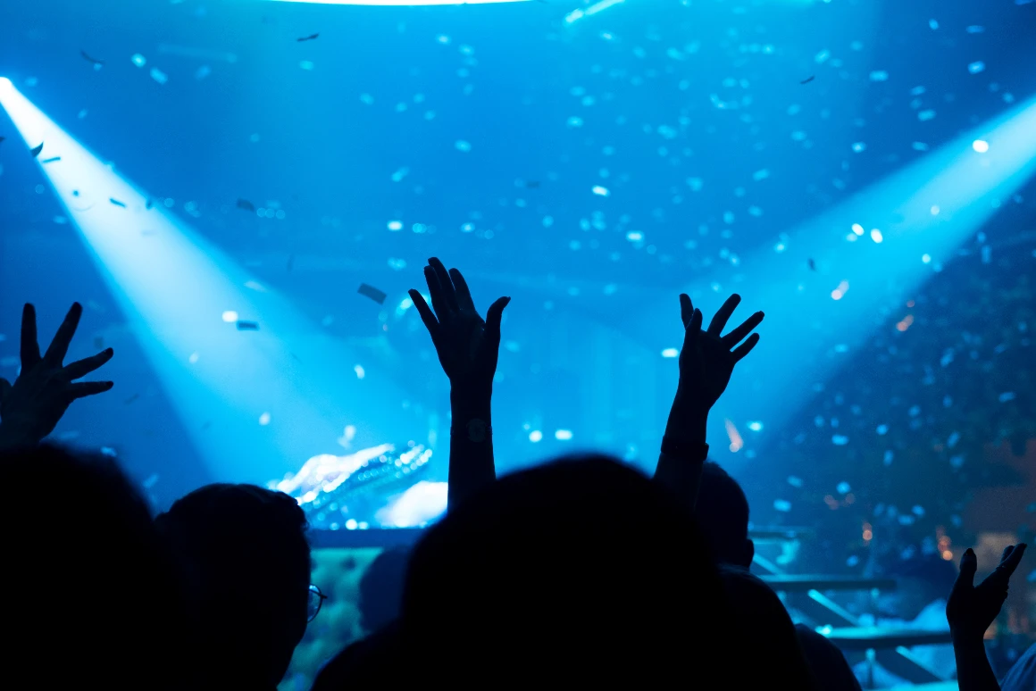 Audience raising their hands during a blue-lit live show at Tabana in Playa de Palma.