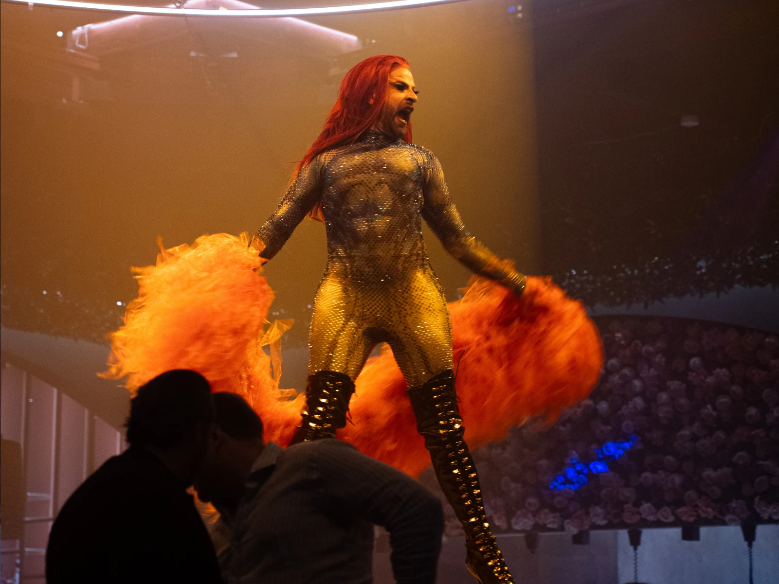 Cabaret performer in a gold costume during a live act at Tabana