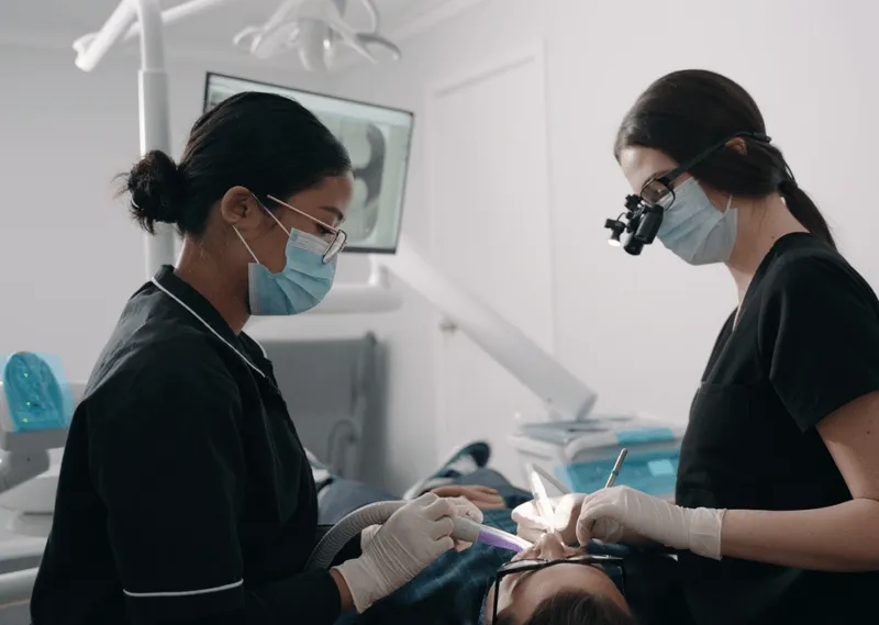 A woman getting her teeth checked by a dentist.