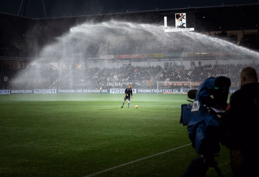Football field being watered at night