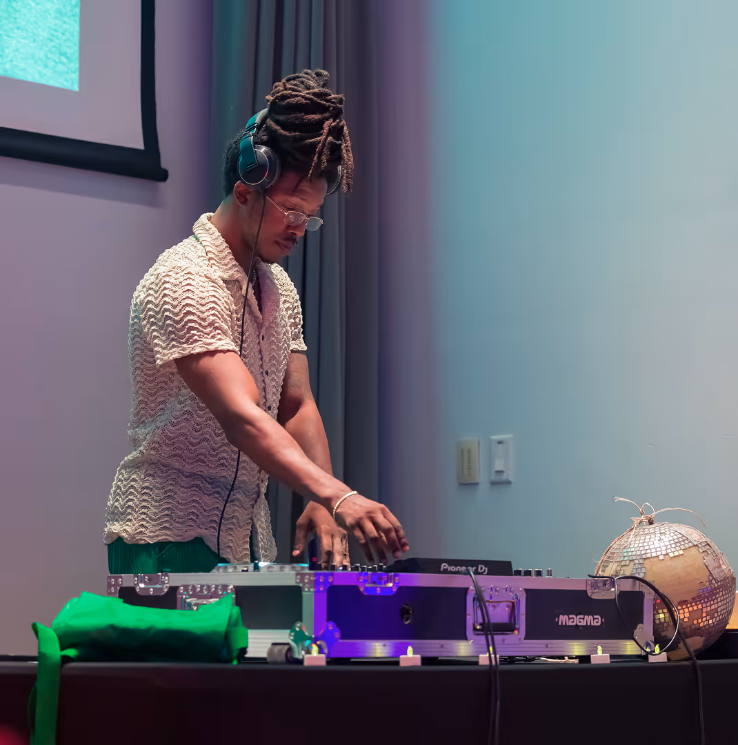 DJ plays music on stage at Overtown Performing Arts Center event