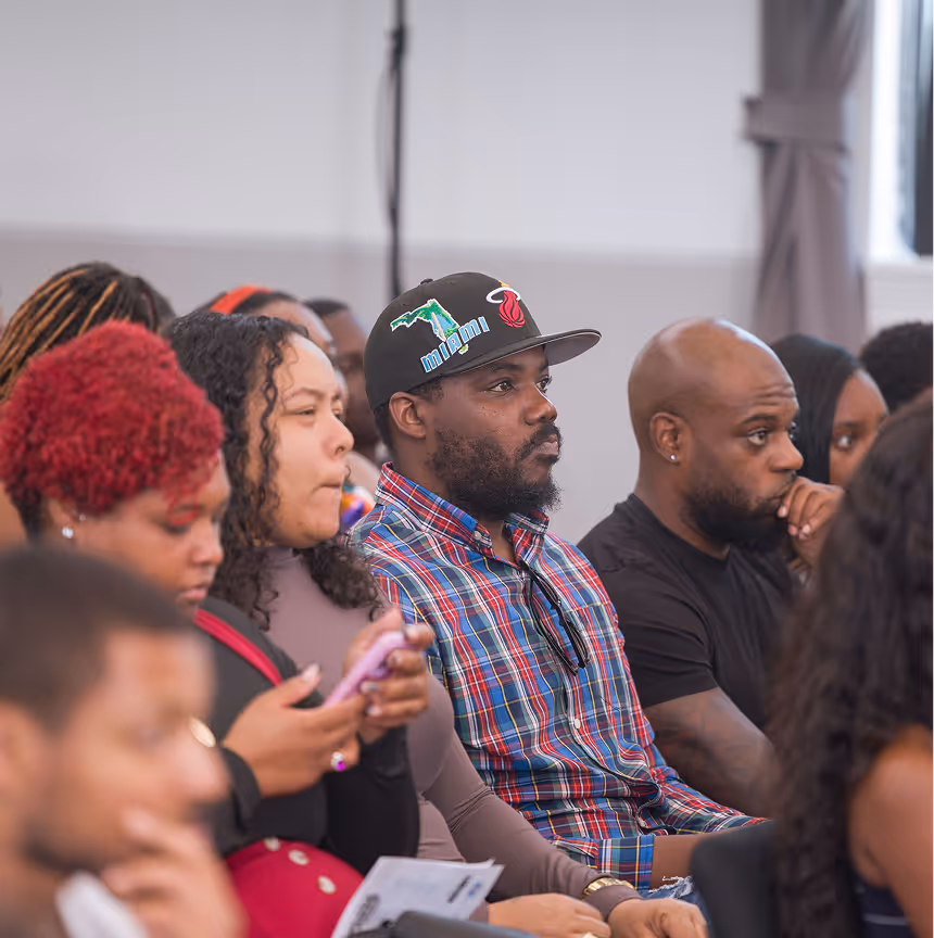 Guests attentively listen during a speaker event at Overtown Performing Arts Center