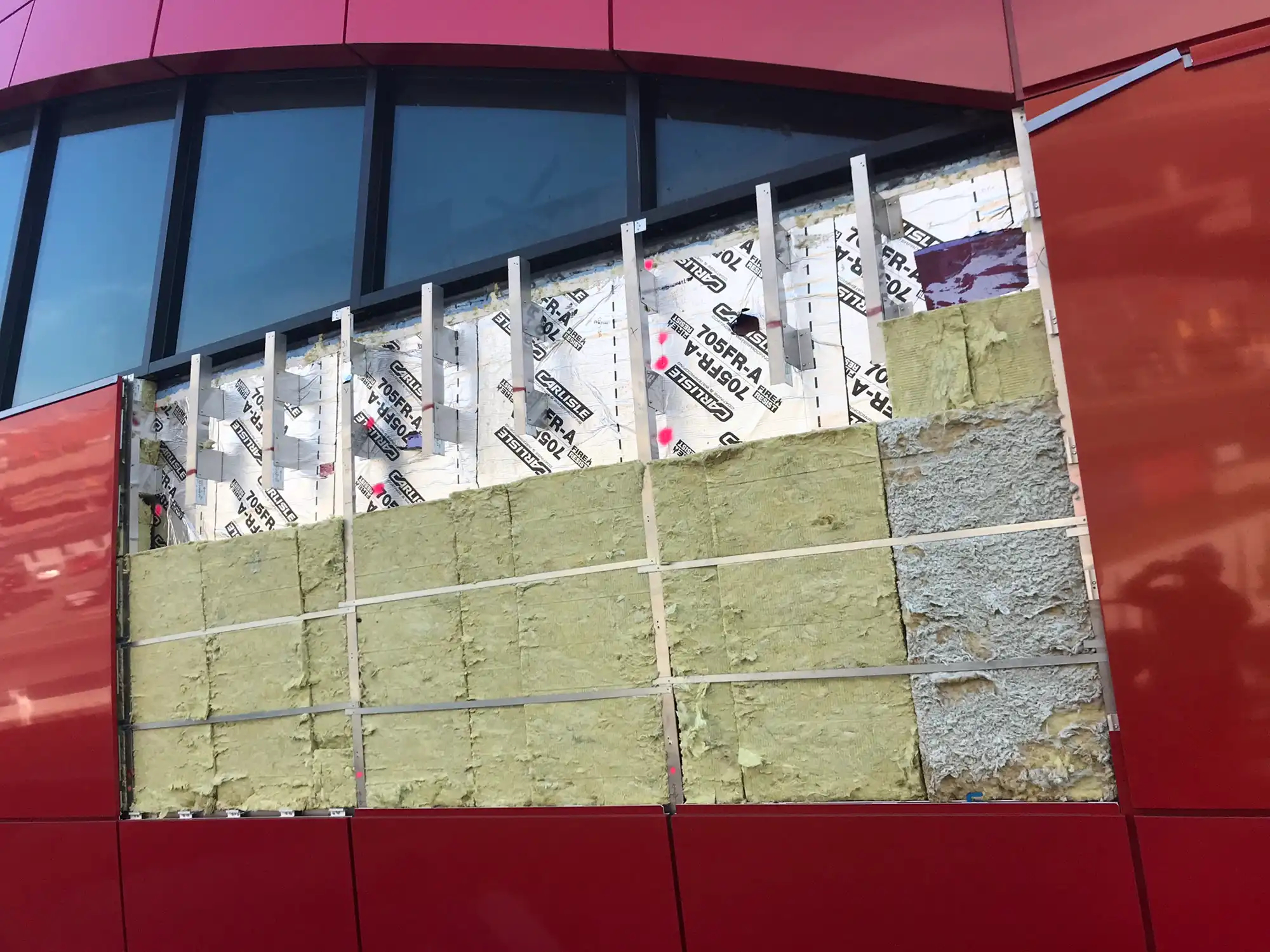 Deetailed images of doubly curved façade assembly with mineral wool insulation and panel support system at Logan Terminal D Boston