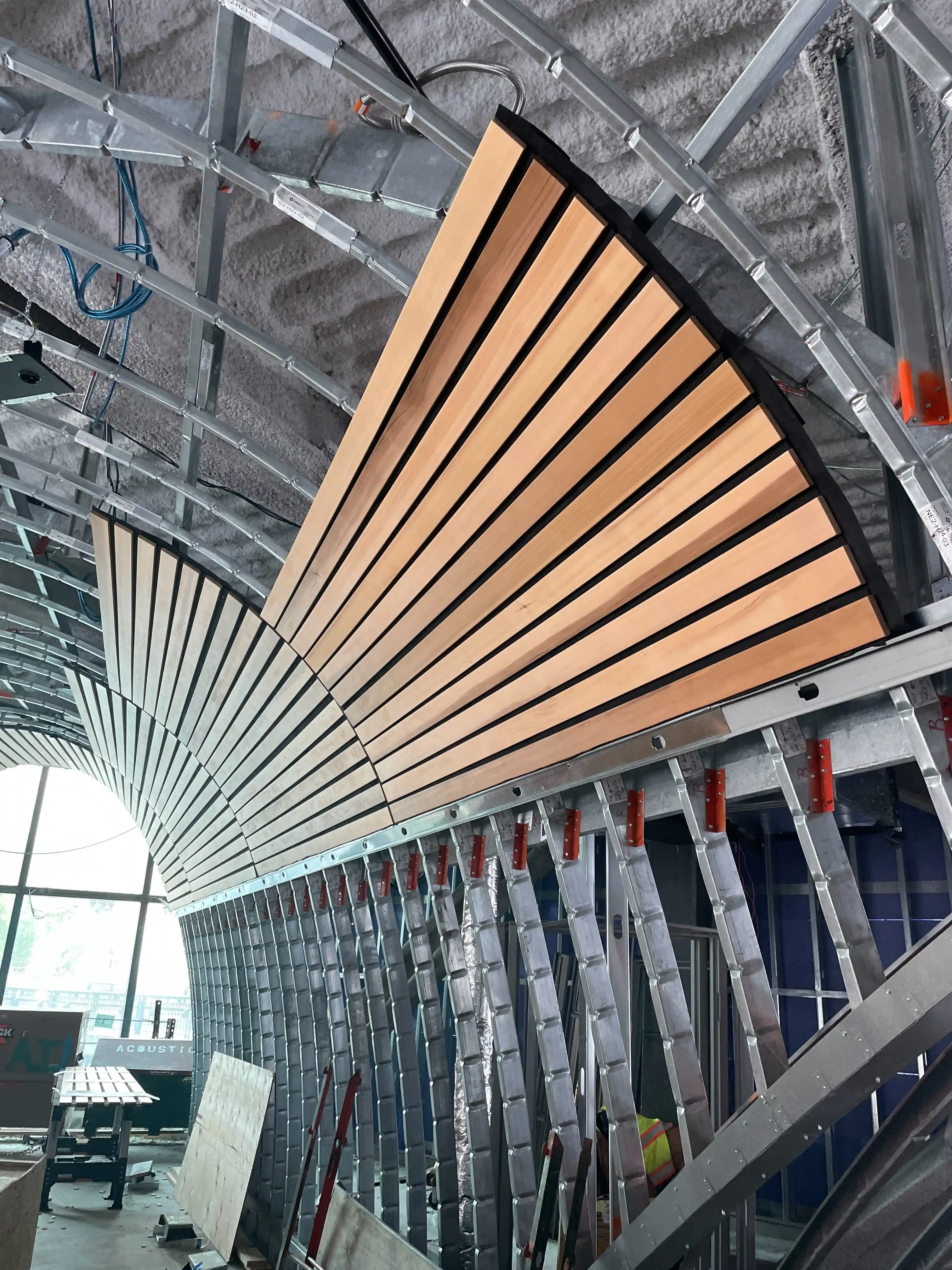 Wood soffit mock up where panels are attached to precision curved cold formed steel framing system at 10 World Trade Boston