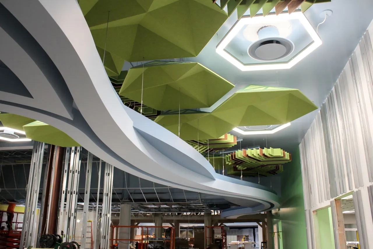 Completed freeform curved soffit at Redford Library constructed with prefabricated cold formed steel panel system and integrated lighting