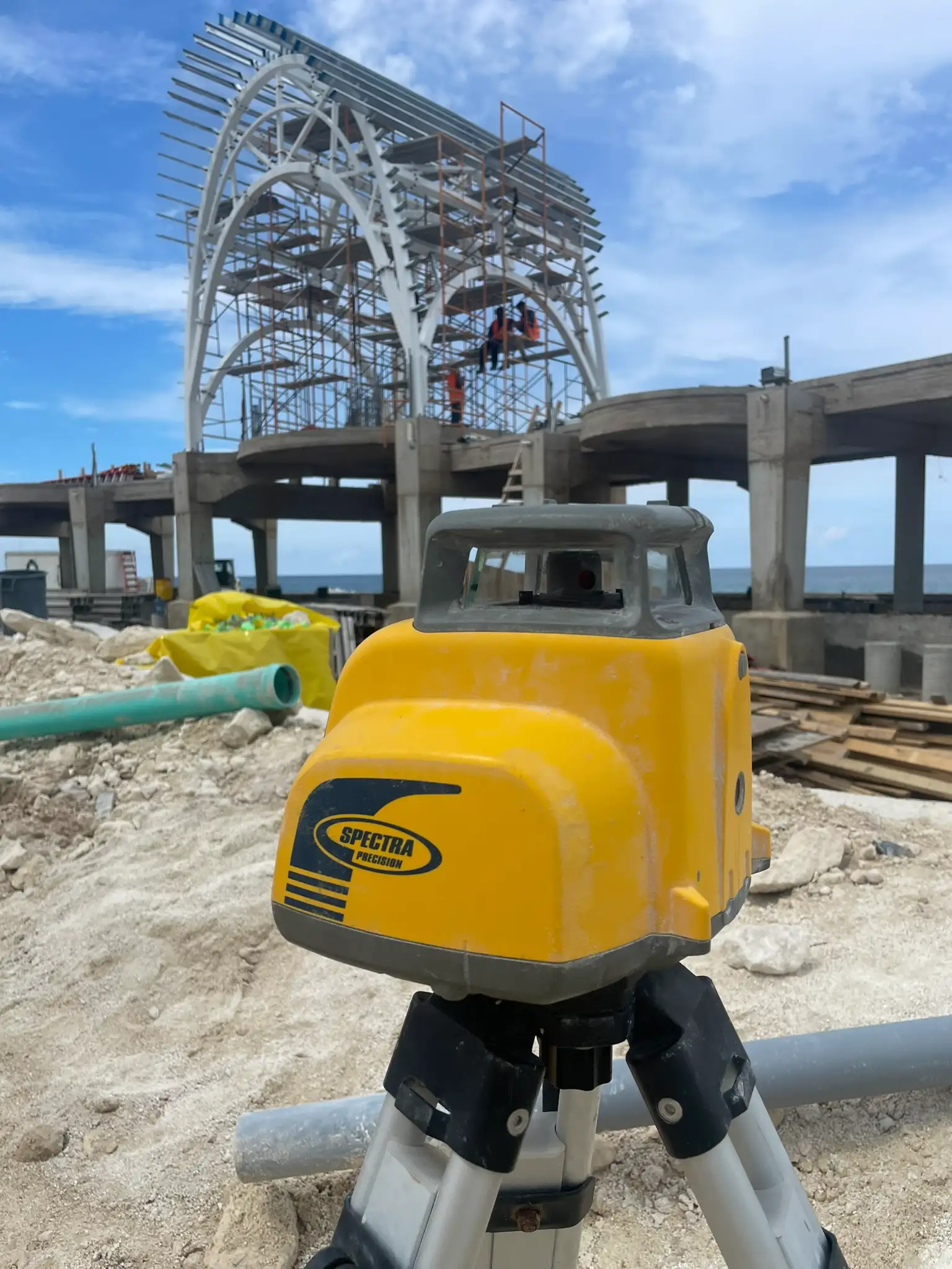 Digital survey equipment coordinating curved pavilion steel framing layout with 3D project model at Paradise Island