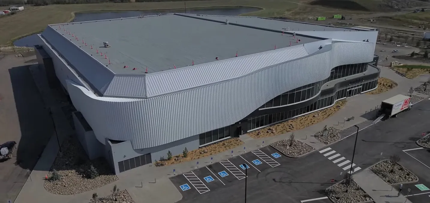 Completed architectural façade with sweeping curved geometry built using prefabricated cold formed steel trusses at Cenovus Energy Hub