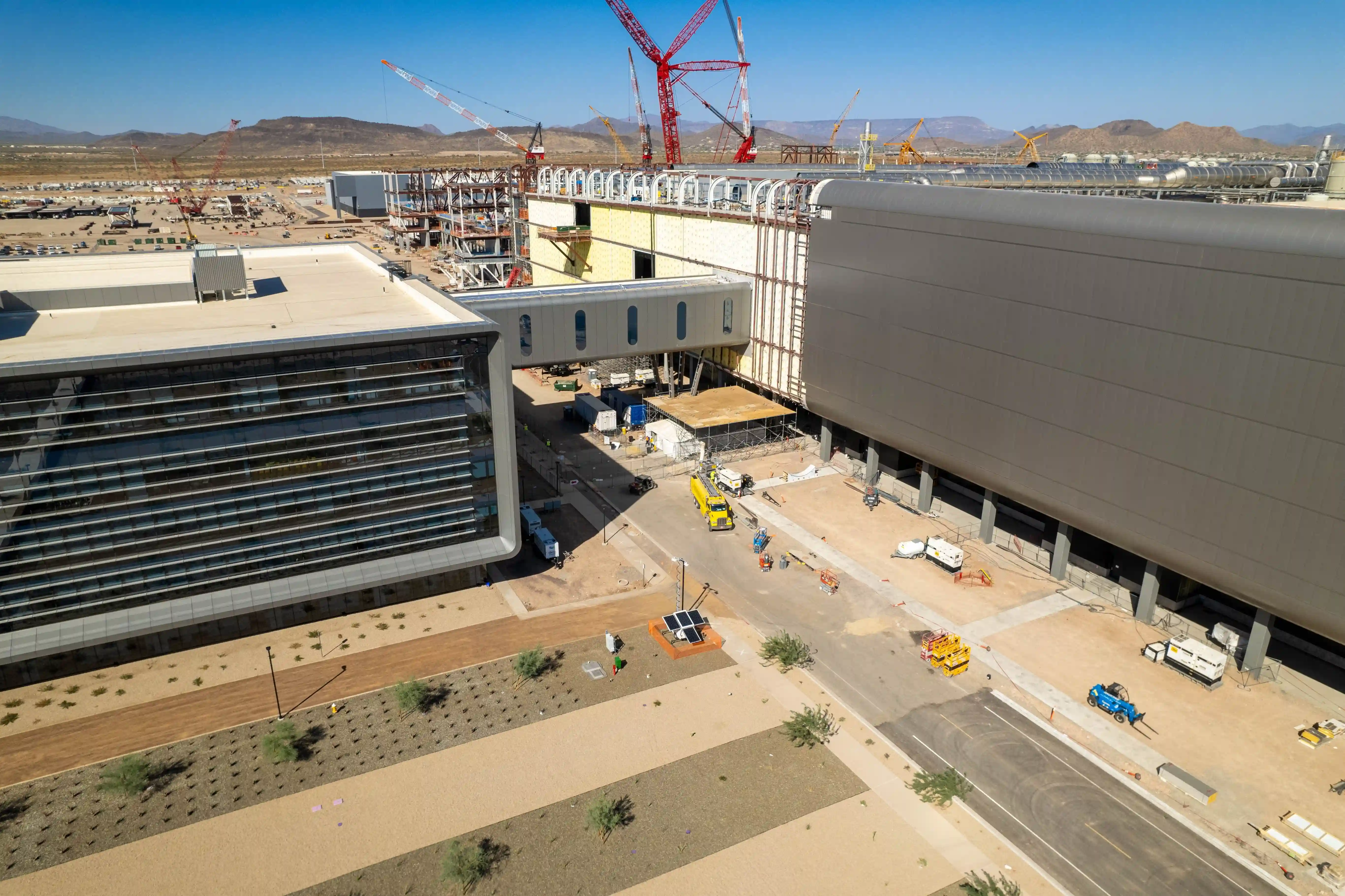 Curved cold formed metal framing installed at building corner to support radius façade geometry at TSMC campus