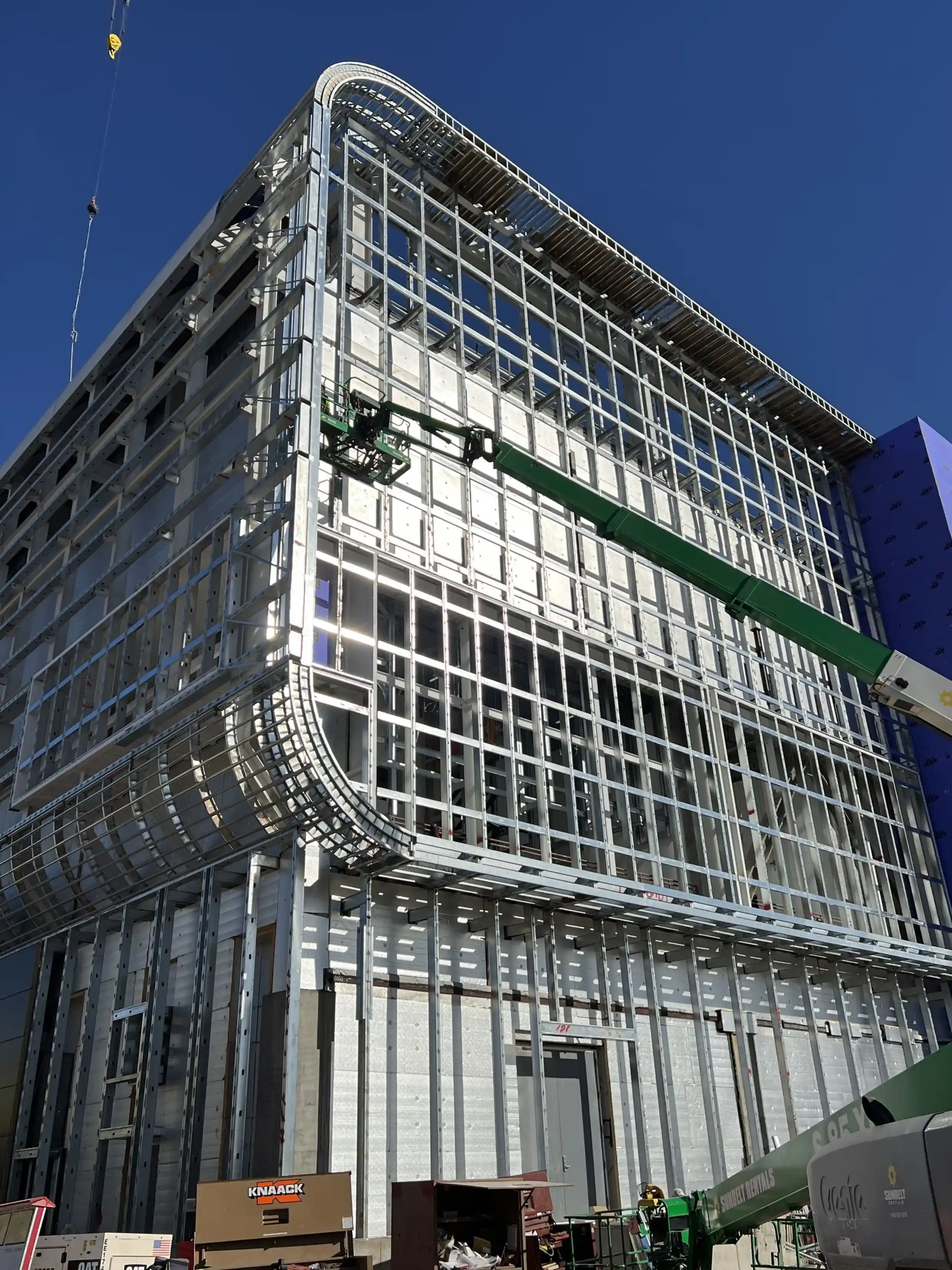 TSMC semiconductor facility exterior featuring curved architectural façade panels supported by precision radius framing components