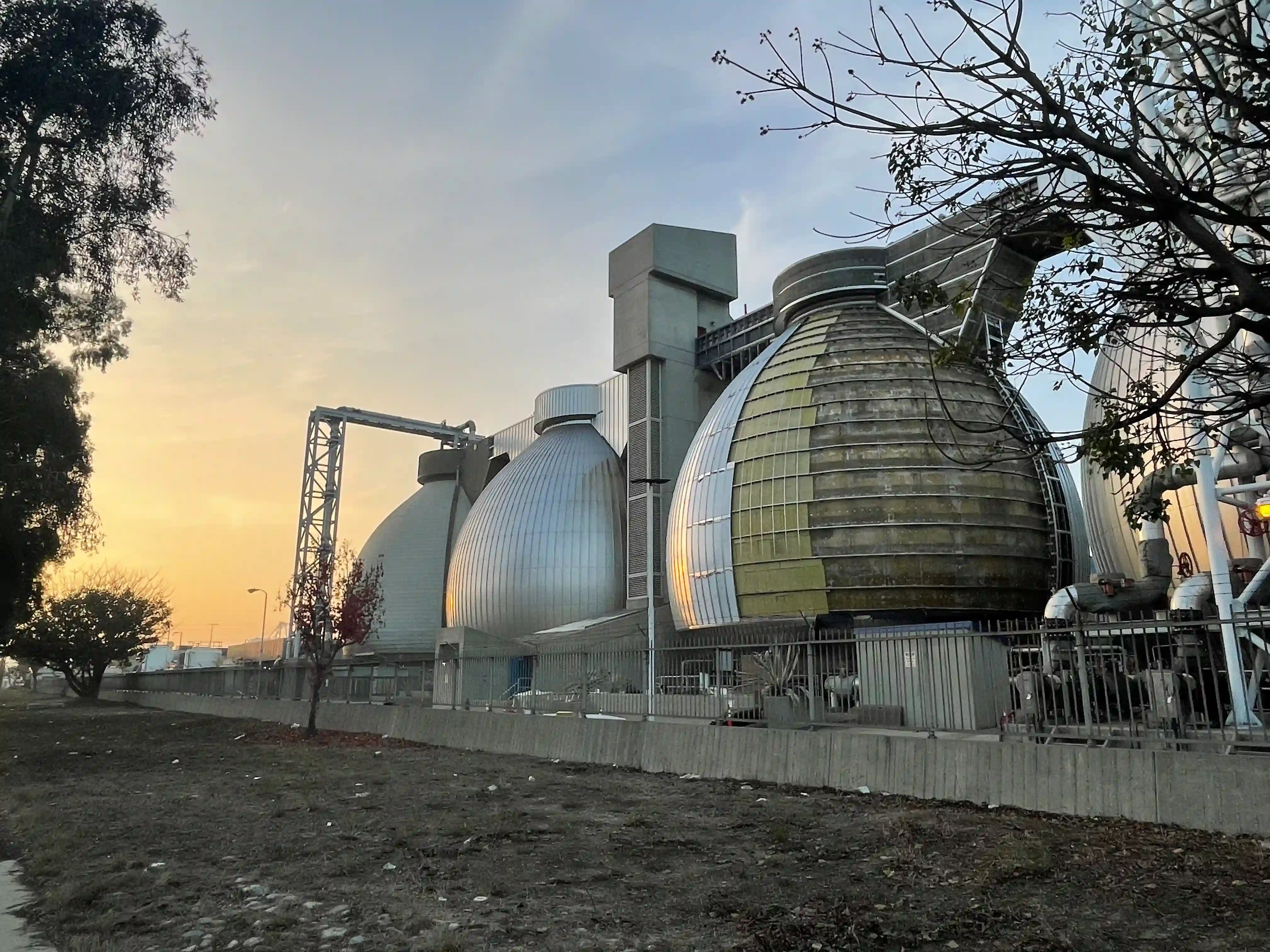Multiple spherical digesters at LA Terminal facility during phased exterior cladding installation using curved panel systems