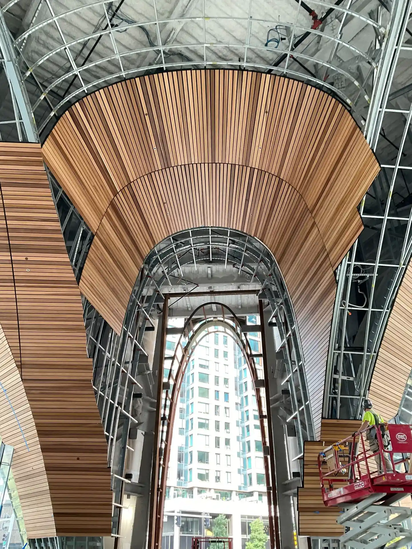 Wood soffit panels attached to precision curved cold formed steel framing system at 10 World Trade Boston